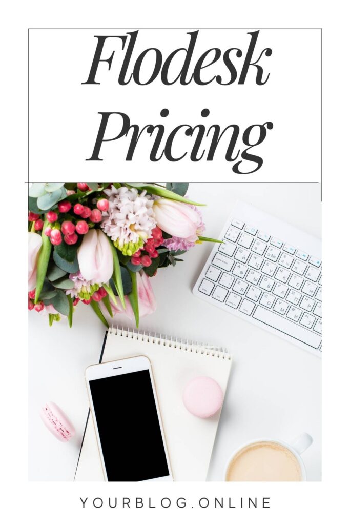 Computer keyboard on a white desk with flowers and the wording Flodesk pricing
